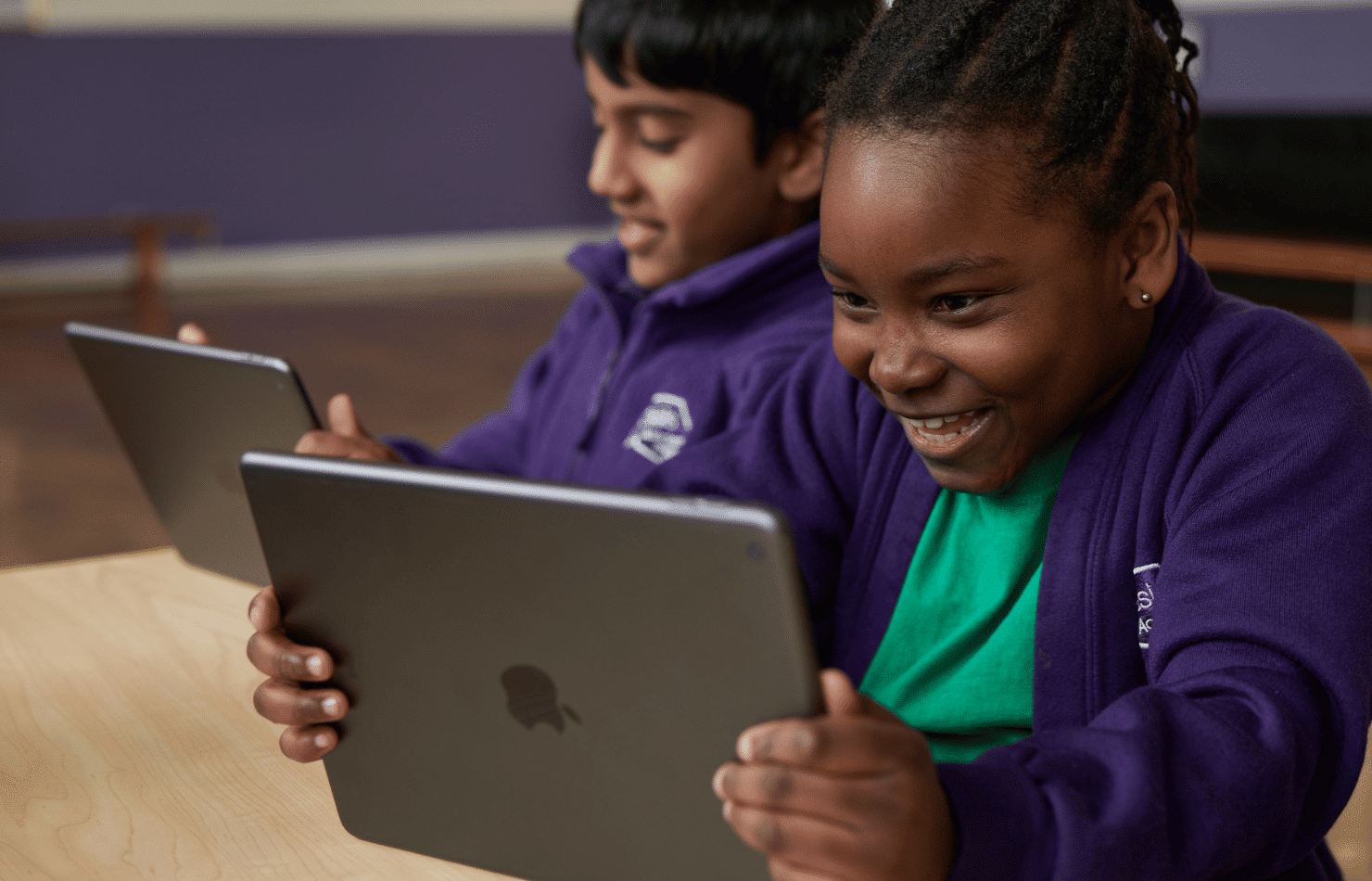 Two primary school students using iPad for learning in class