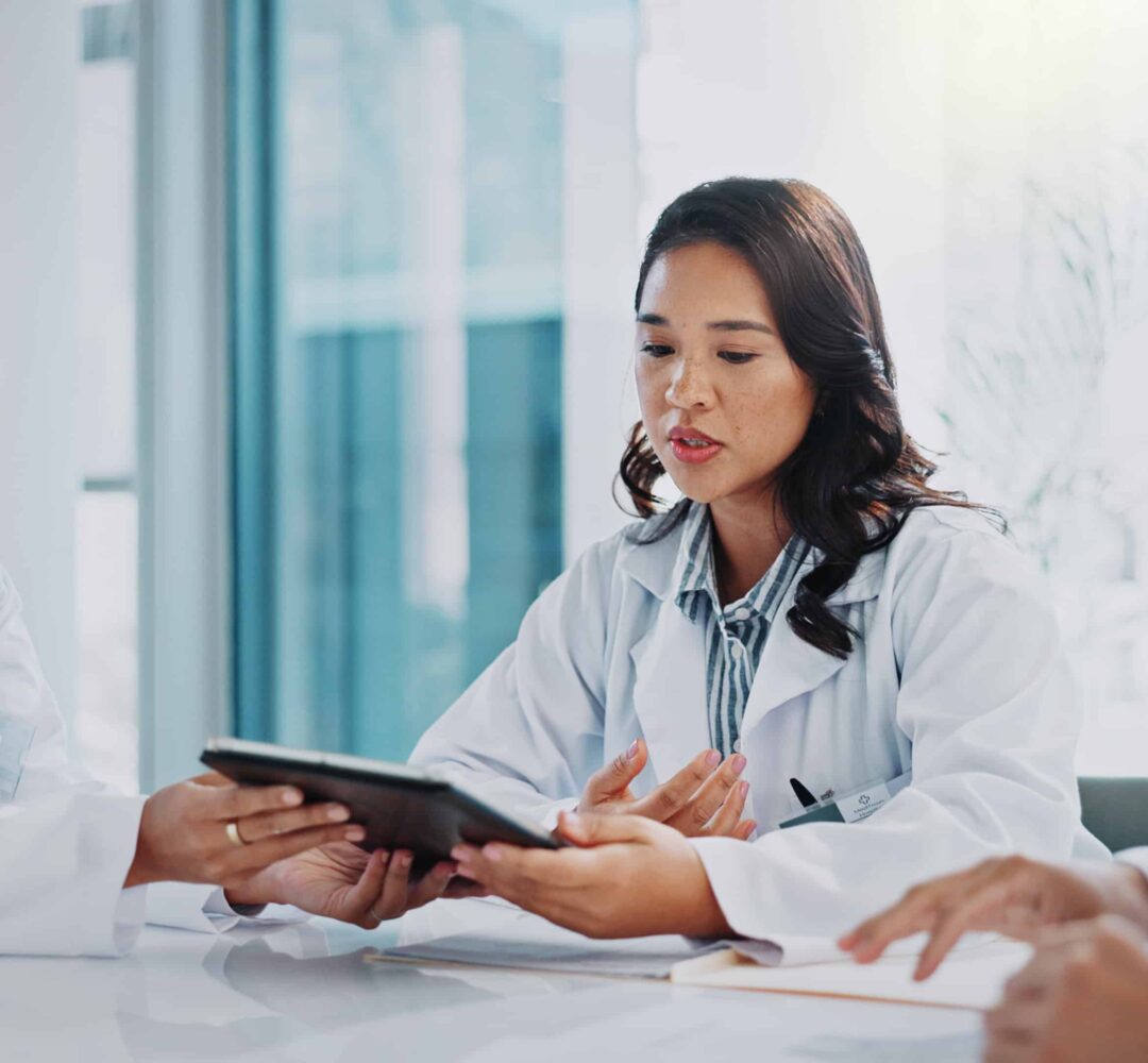 Doctor, meeting and tablet with planning, conversation and collaboration for surgery in a hospital